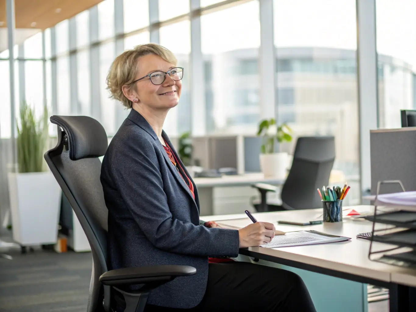A senior South African professional smiling confidently while reviewing retirement plans, representing retirement planning services.